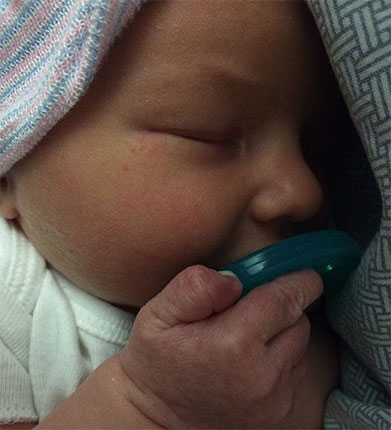 Infant Sophia sleeping with a pacifier