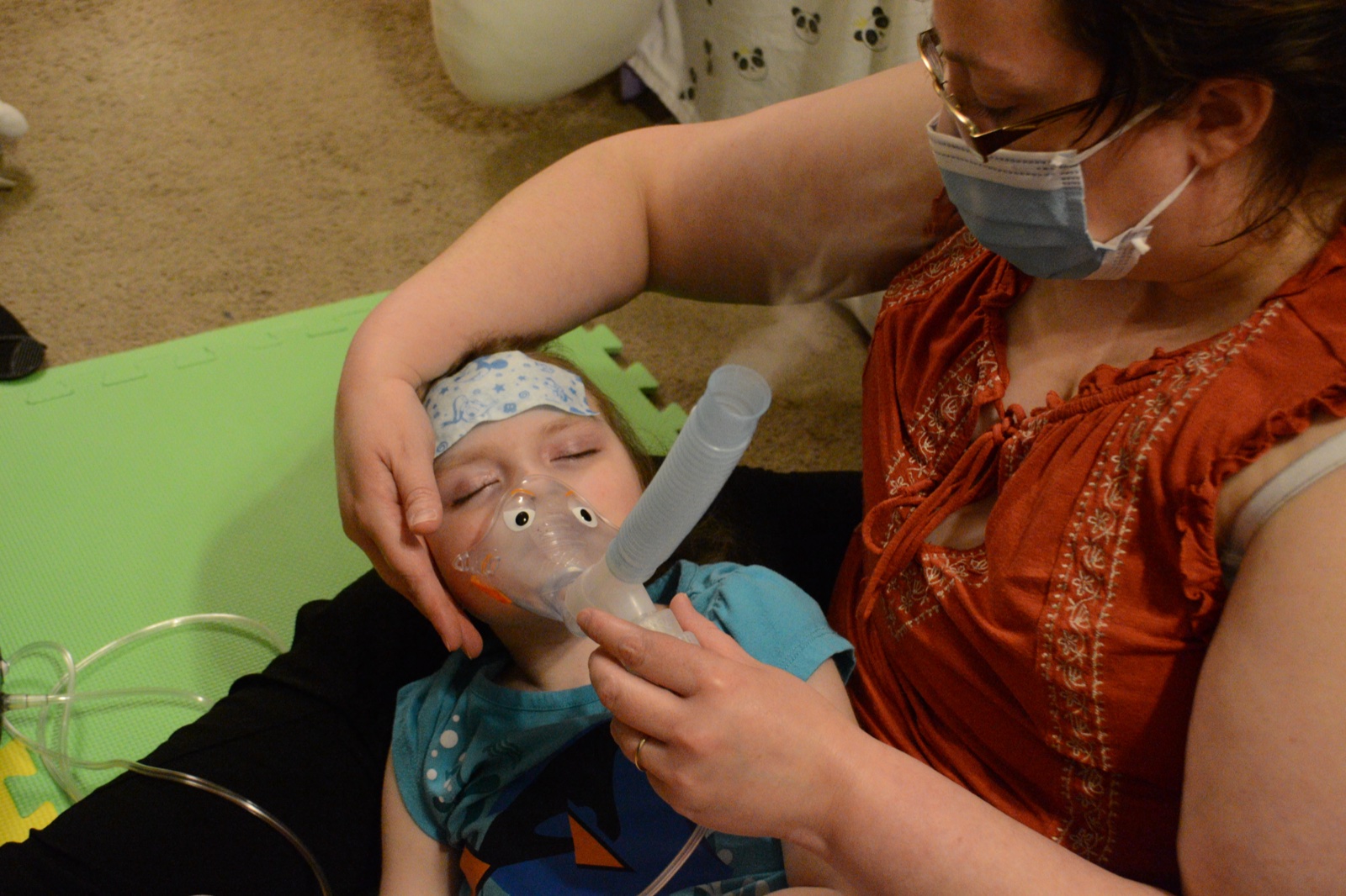 Sophia receiving breathing treatment at home in 2021
